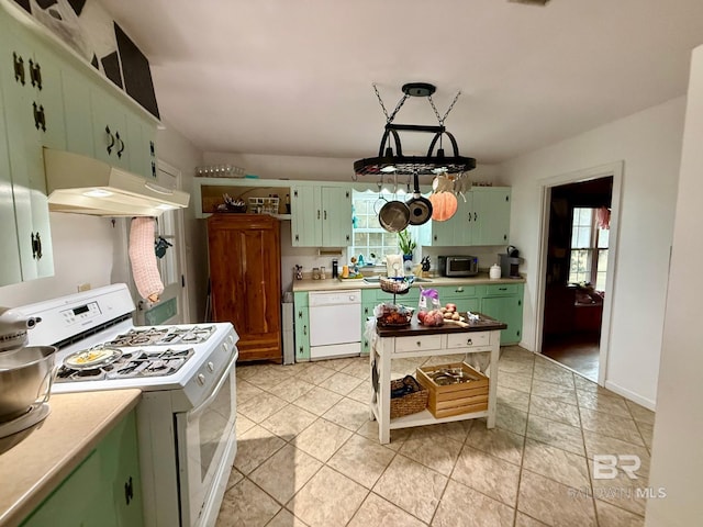 kitchen with white appliances, decorative light fixtures, green cabinets, and a wealth of natural light