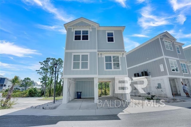 2831 Salt Dr, Orange Beach, AL 36561 - view of front facade featuring a carport, driveway, and board and batten siding