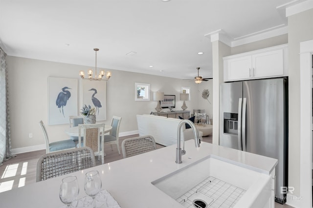 2831 Salt Dr, Orange Beach, AL 36561 - kitchen featuring a sink, stainless steel fridge with ice dispenser, baseboards, light countertops, and white cabinetry