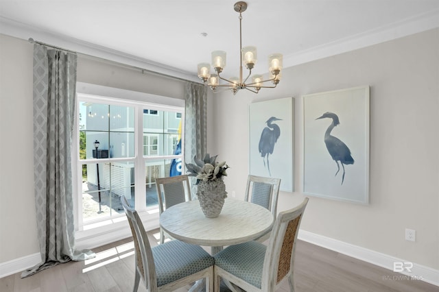 2831 Salt Dr, Orange Beach, AL 36561 - dining area featuring a chandelier, wood finished floors, and baseboards