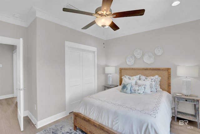 2831 Salt Dr, Orange Beach, AL 36561 - bedroom with baseboards, a closet, light wood-style floors, and ceiling fan