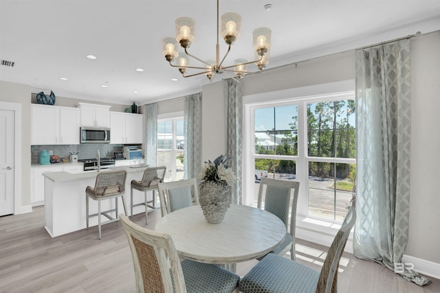 2831 Salt Dr, Orange Beach, AL 36561 - dining room with a chandelier, light wood-type flooring, ornamental molding, and recessed lighting