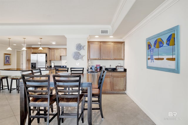 dining room featuring ornamental molding and light tile patterned flooring