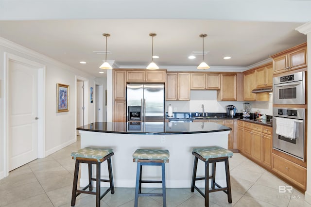 kitchen featuring decorative light fixtures, appliances with stainless steel finishes, ornamental molding, and a kitchen island