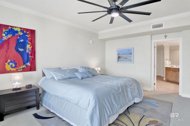 carpeted bedroom featuring ceiling fan, ensuite bathroom, and crown molding