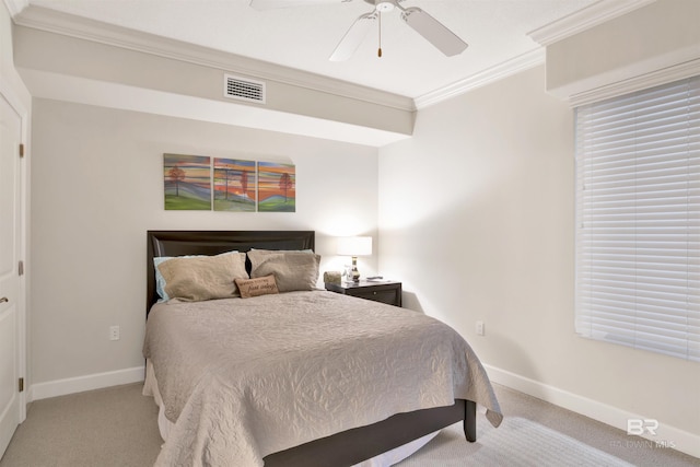 carpeted bedroom featuring ceiling fan and crown molding