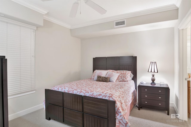 carpeted bedroom featuring ceiling fan and crown molding