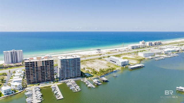 birds eye view of property featuring a water view and a beach view