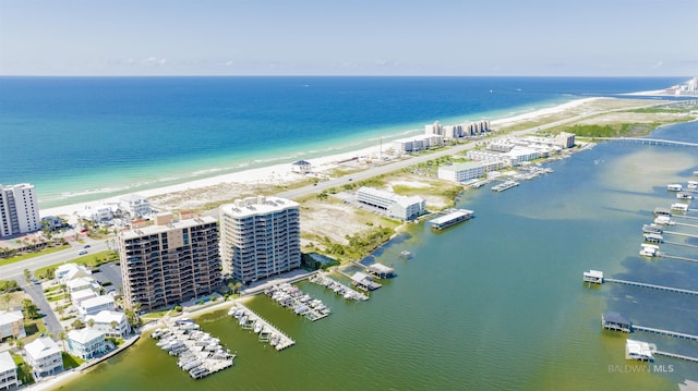 drone / aerial view featuring a water view and a beach view