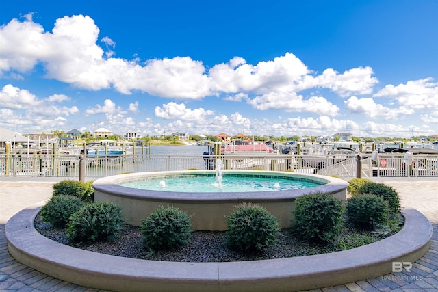 view of swimming pool with a water view