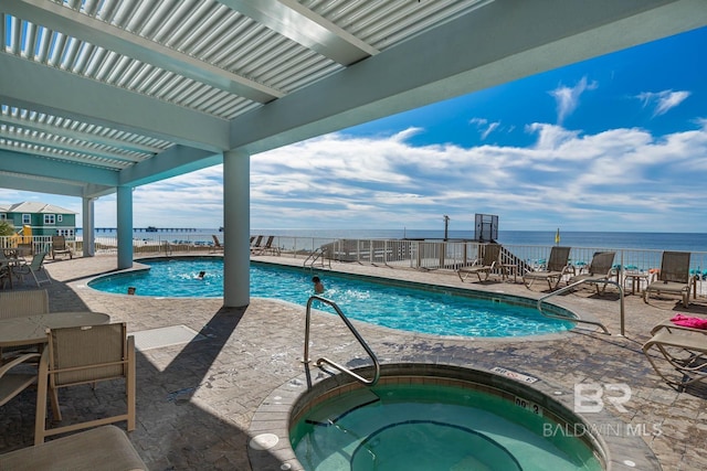 527 E Beach Blvd Unit 603, Gulf Shores, AL 36542 - community pool featuring a hot tub, a patio area, and a water view
