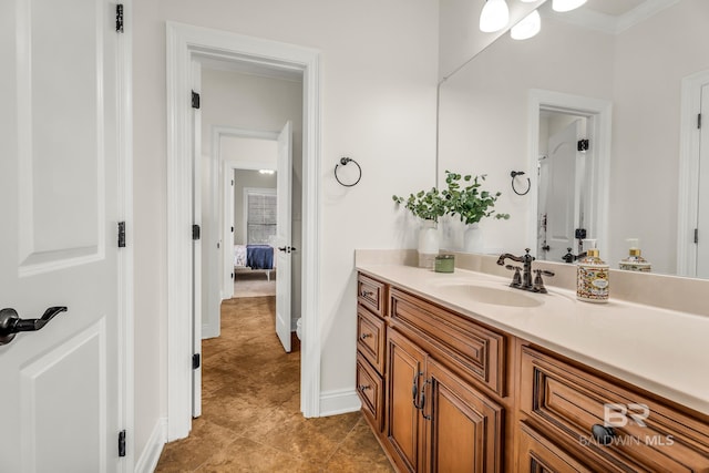 bathroom featuring tile patterned flooring, crown molding, and vanity