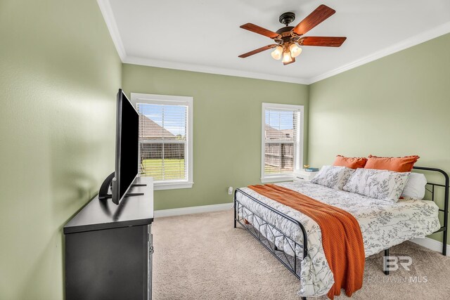 bedroom with ornamental molding, light carpet, baseboards, and multiple windows