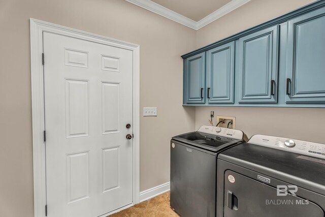 laundry area with light tile patterned floors, cabinet space, ornamental molding, washer and dryer, and baseboards