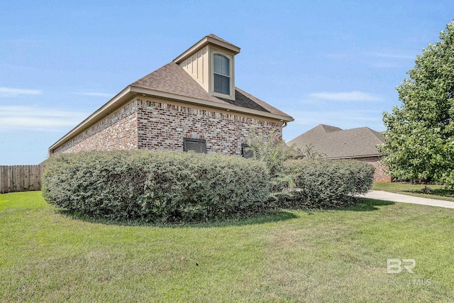 view of side of property with a yard and central AC unit