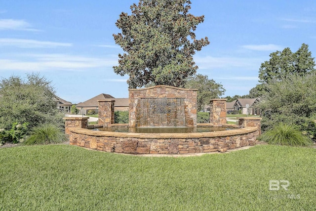 community / neighborhood sign with a lawn