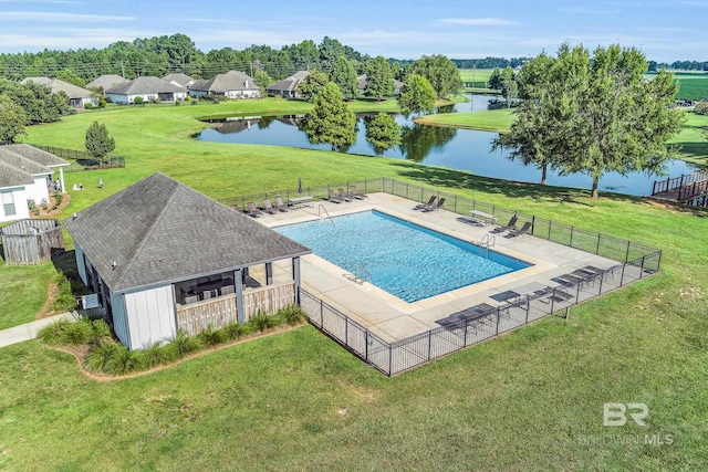 view of swimming pool with a water view, a patio area, and a yard