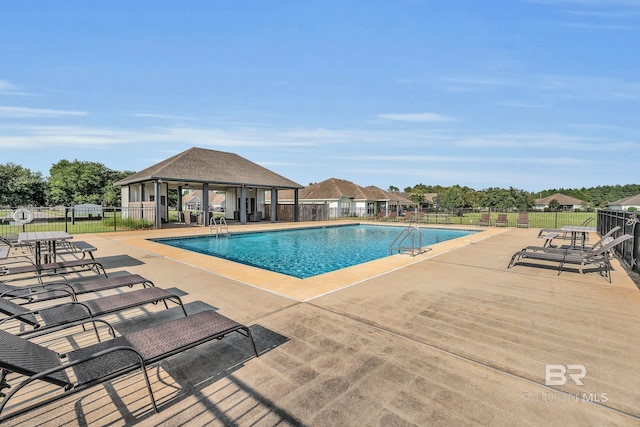 view of swimming pool with a patio