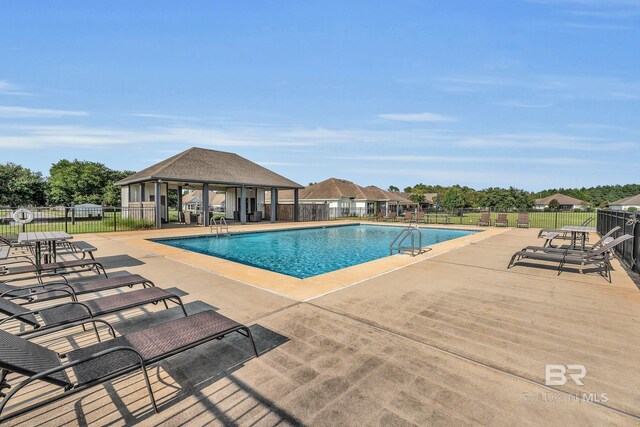 pool featuring a patio area, fence, and a gazebo