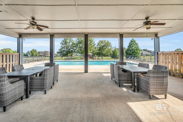 view of patio with a ceiling fan, outdoor dining area, fence, and a fenced in pool