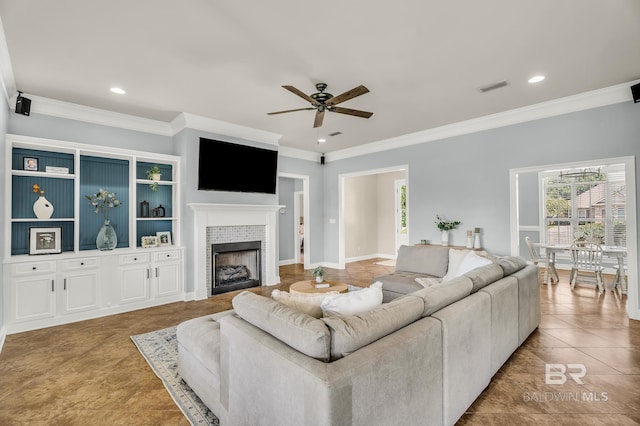 living room featuring ceiling fan, crown molding, built in features, and light tile patterned floors