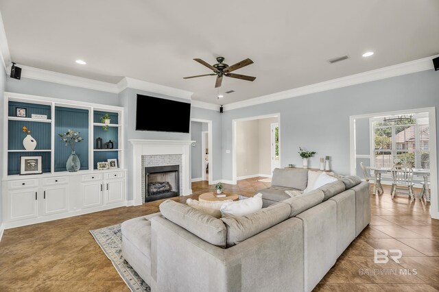 living area featuring a fireplace, recessed lighting, visible vents, ornamental molding, and ceiling fan