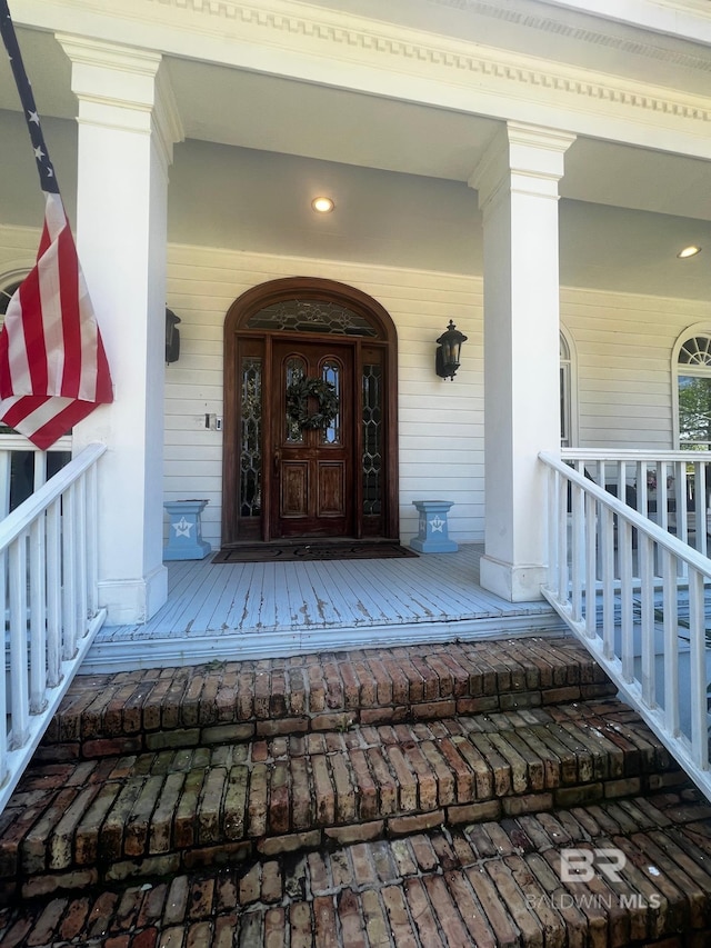 doorway to property featuring covered porch