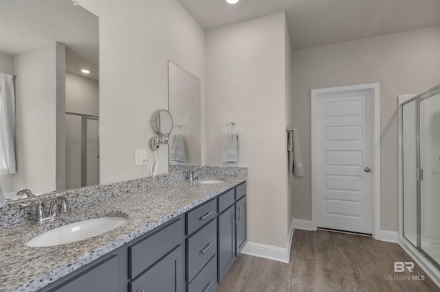 2345 Laurel St, Semmes, AL 36575 - full bath featuring wood finished floors, a shower stall, double vanity, and recessed lighting