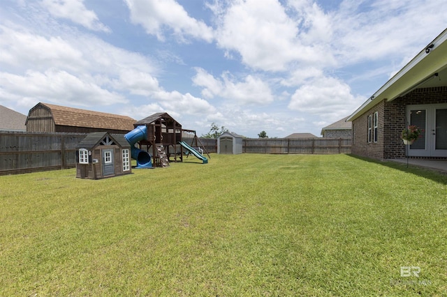 2345 Laurel St, Semmes, AL 36575 - fenced backyard with a storage unit, a playground, and french doors