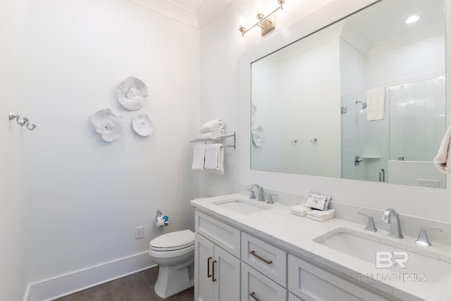2471 Saltgrass Way, Orange Beach, AL 36561 - bathroom with crown molding, an enclosed shower, toilet, vanity, and hardwood / wood-style flooring