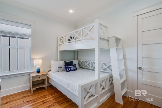 2471 Saltgrass Way, Orange Beach, AL 36561 - bedroom featuring hardwood / wood-style flooring and ornamental molding