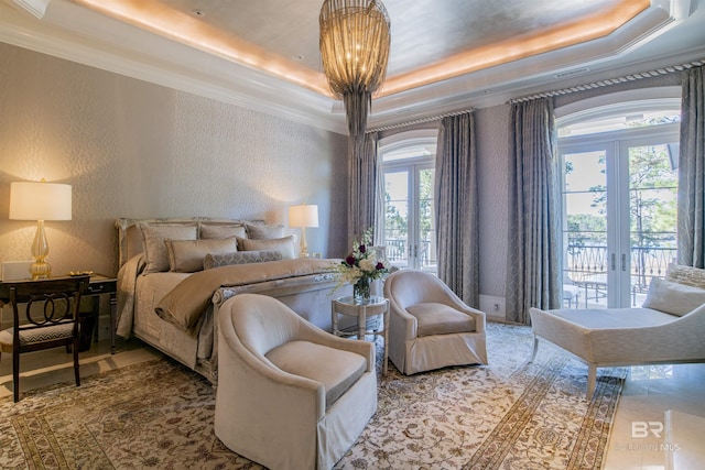 bedroom featuring ornamental molding, french doors, access to outside, and a raised ceiling