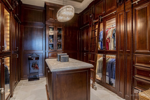 spacious closet with a chandelier