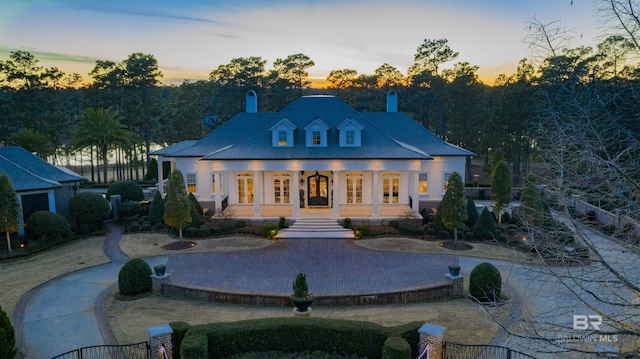 back house at dusk featuring french doors