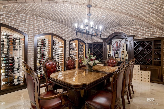 wine room featuring a chandelier, vaulted ceiling, brick ceiling, and electric panel