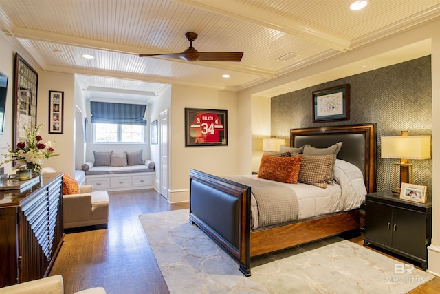 bedroom featuring ornamental molding, beamed ceiling, ceiling fan, and light wood-type flooring