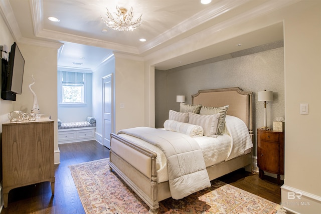 bedroom featuring dark hardwood / wood-style flooring, a raised ceiling, ornamental molding, and a notable chandelier