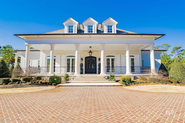 view of front of house featuring french doors and covered porch