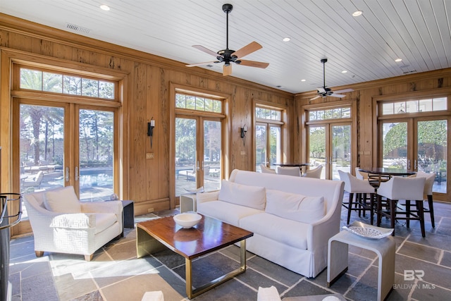 living room featuring french doors, wood walls, ceiling fan, and wood ceiling