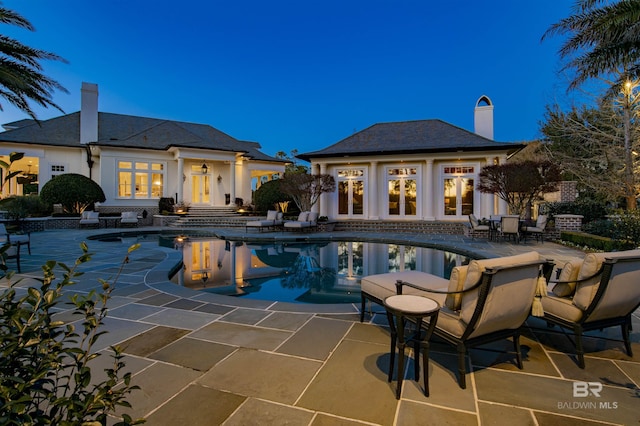 view of pool with a patio area and an outbuilding