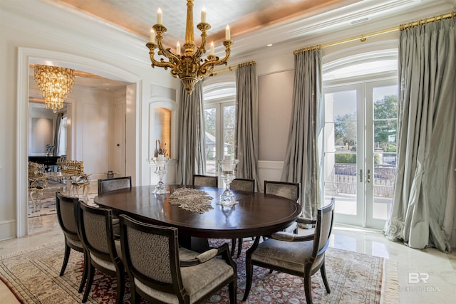 dining space with a notable chandelier, french doors, and crown molding