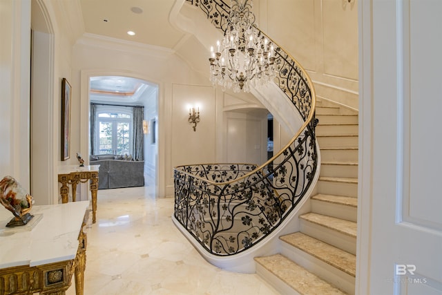 stairway featuring french doors, a notable chandelier, and crown molding