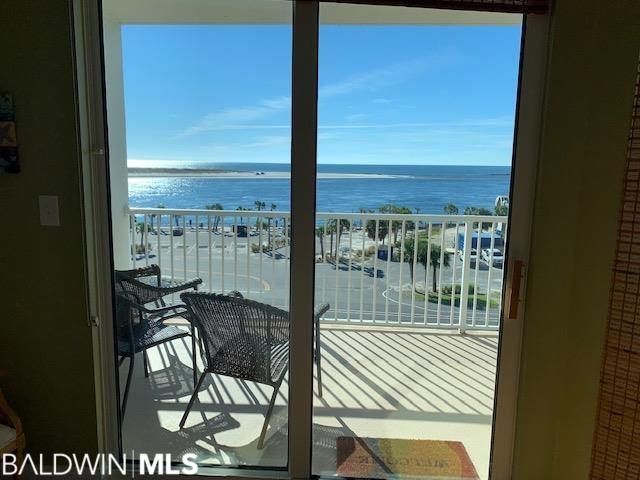 balcony with a beach view and a water view