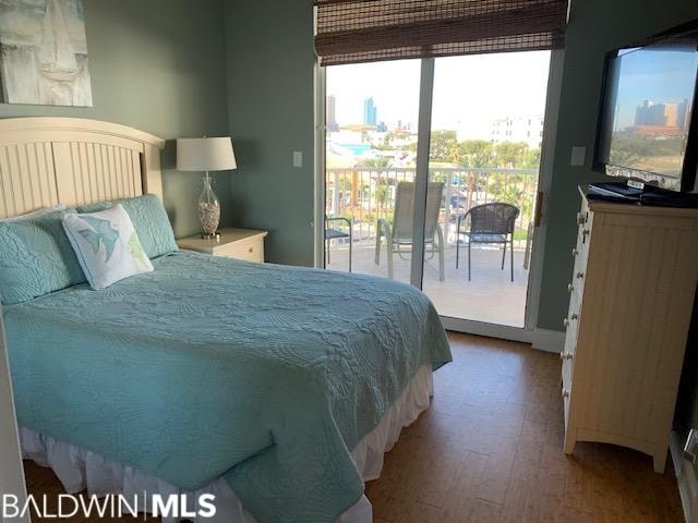 bedroom featuring access to exterior and hardwood / wood-style floors