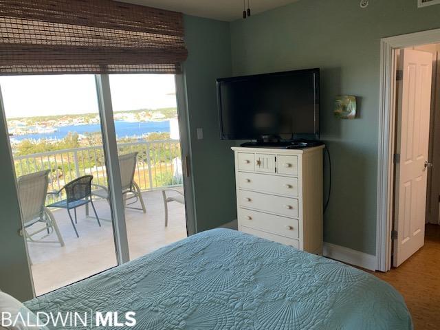 bedroom featuring access to outside and a water view