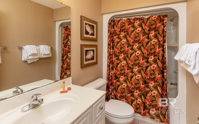 bathroom featuring curtained shower, vanity, and toilet