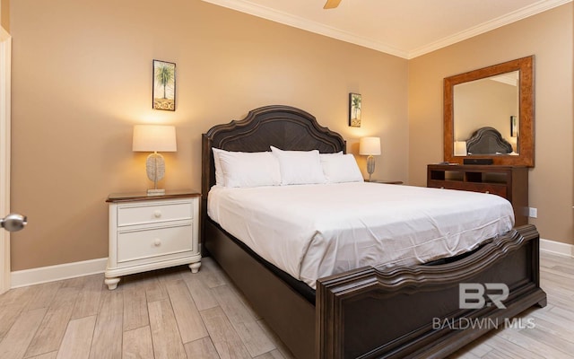 bedroom with light wood-type flooring, crown molding, and baseboards