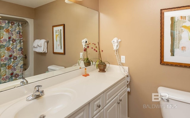 bathroom with vanity, toilet, and a shower with curtain