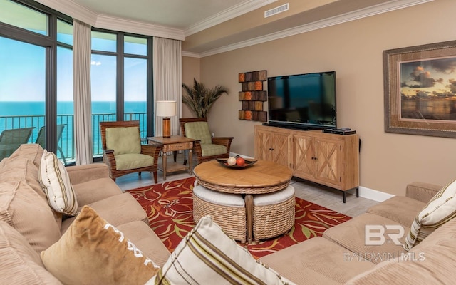 living room featuring crown molding, visible vents, a water view, wood finished floors, and baseboards