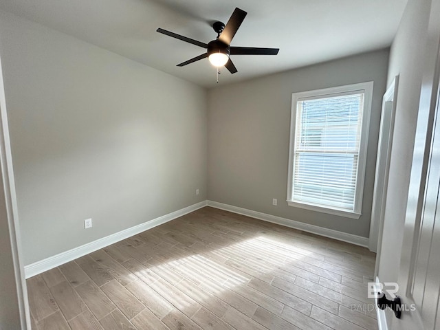 spare room featuring light wood-type flooring and ceiling fan